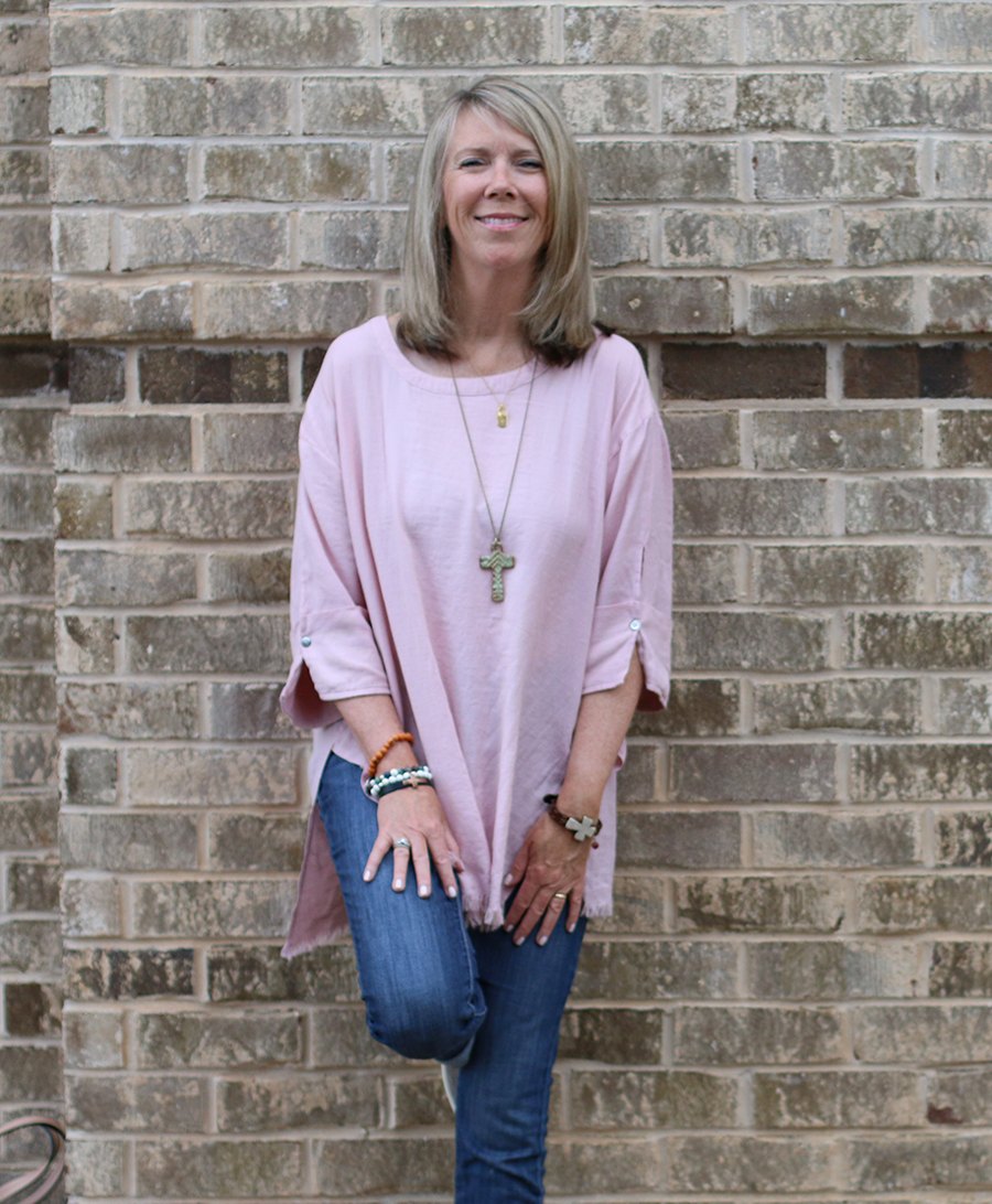Shanon Schneider standing in front of a brick wall